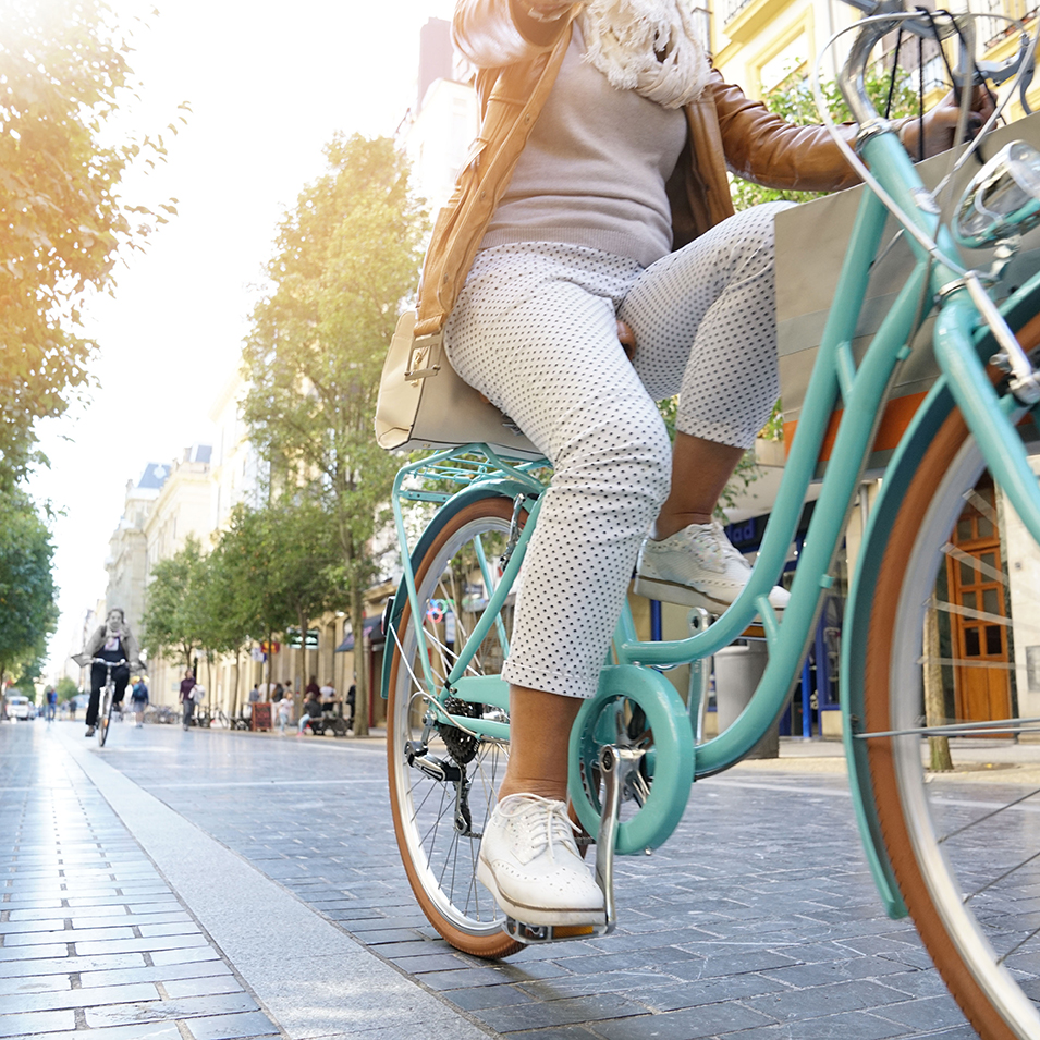 Senior woman riding city bike in town